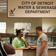 A Detroit Water and Sewerage Department worker helps a customer as she speaks on the phone during a Water Affordability Fair Aug. 2, 2014, in Detroit. Activists say black and brown Detroiters aren’t getting their fair share of media attention for the work they’re doing to bring the city back.
JOSHUA LOTT/GETTY IMAGES